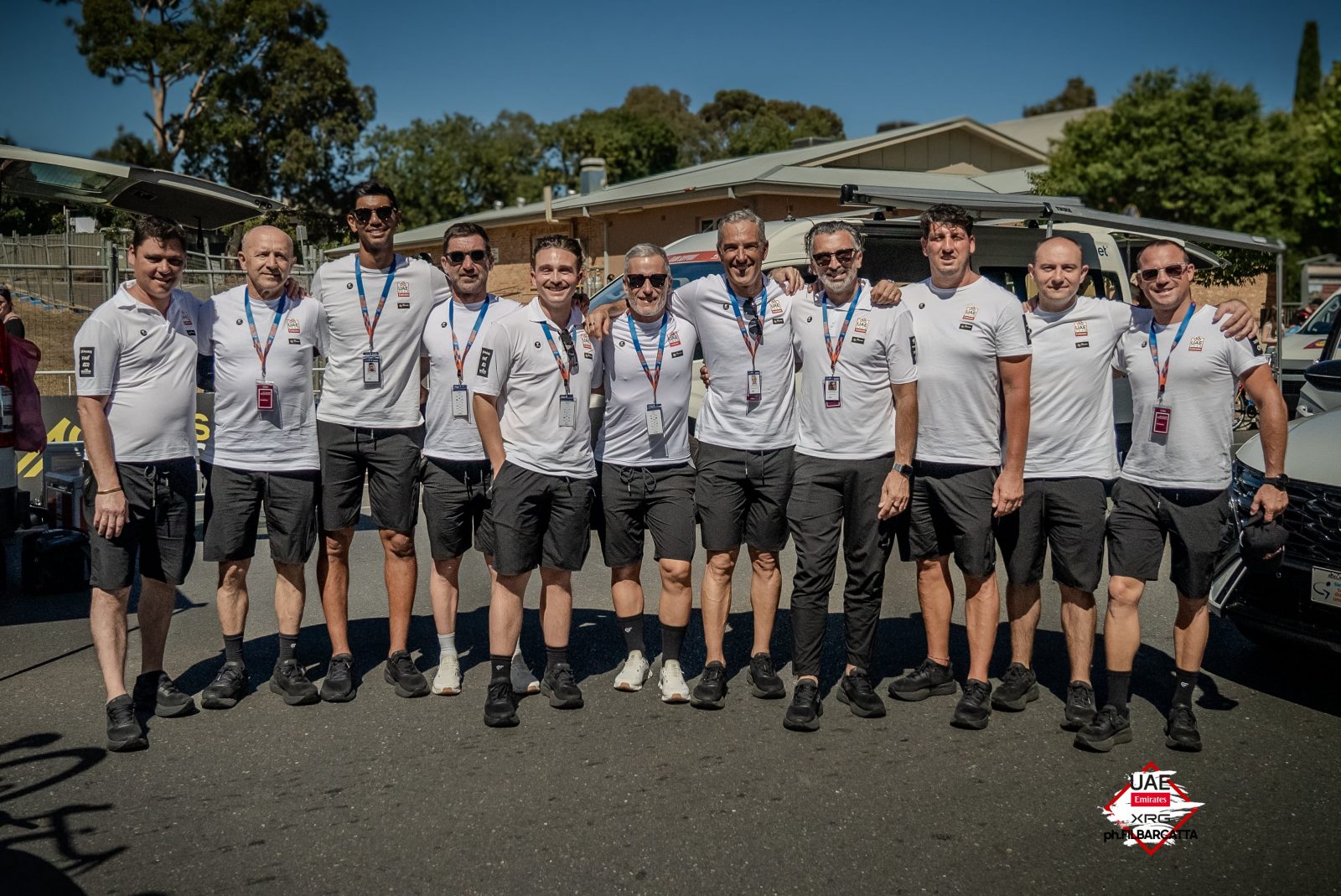 UAE Team Emirates-XRG and Pissei staff take a moment before the stage start